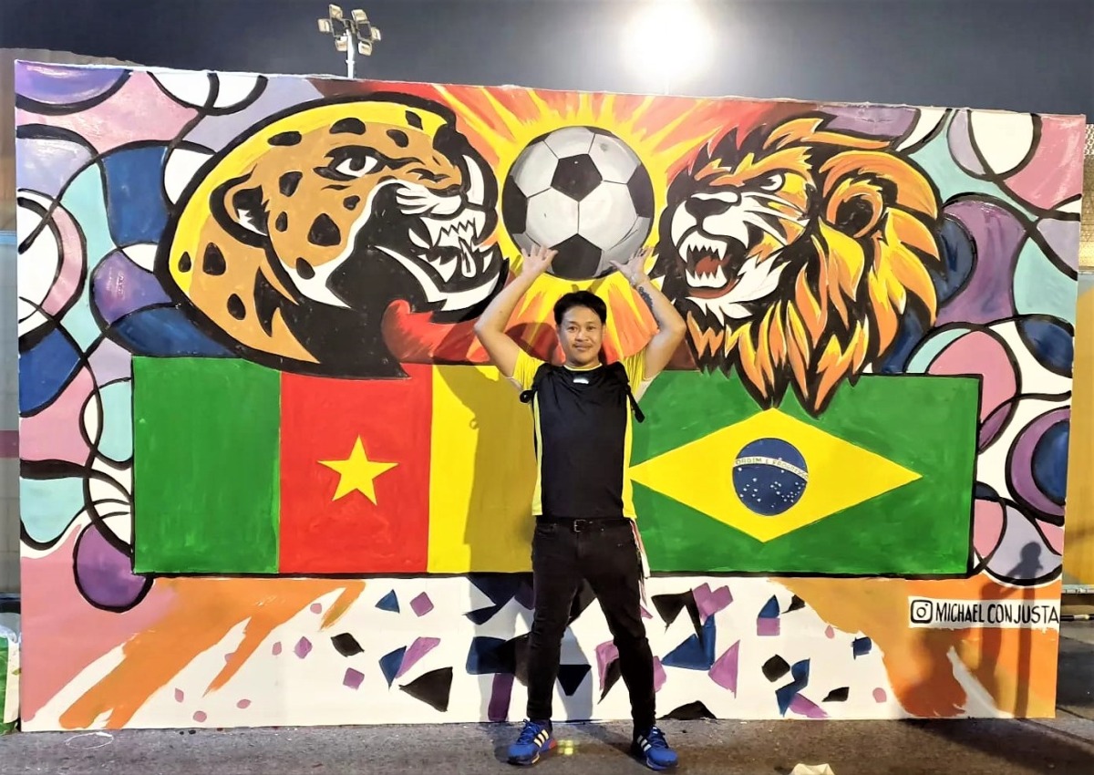 Filipino artist in Qatar paints one mural daily throughout the World Cup
